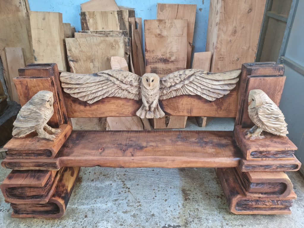 wooden bench with carved barn owls